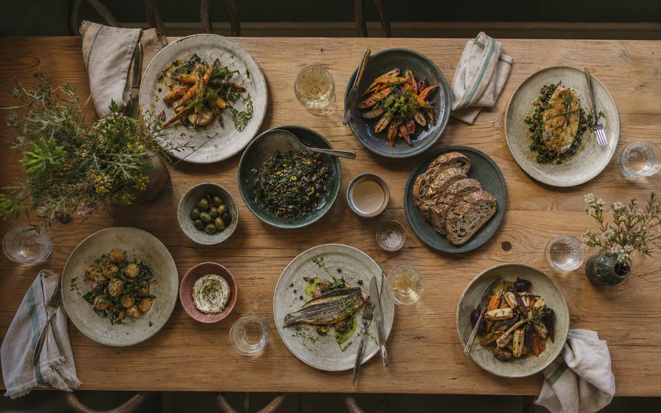 Seasonal plates arranged across a dining table